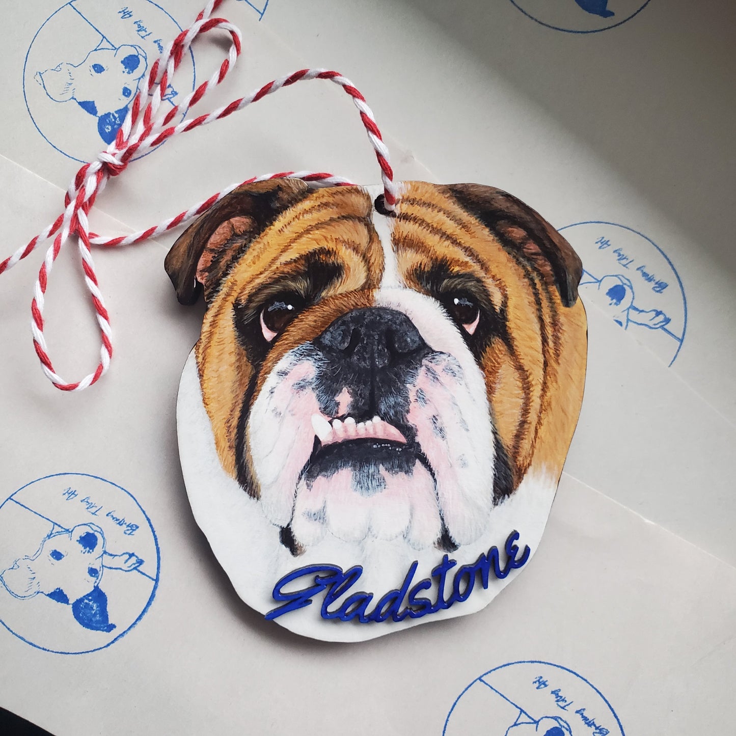 Decorative pet portrait ornament with a dog's face and name 